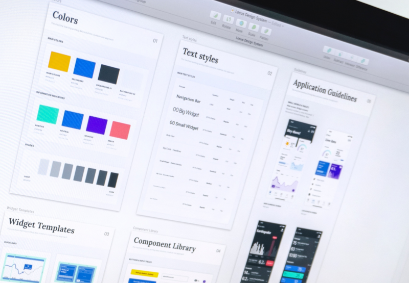 A computer monitor displays a collection of design assets, guides, and components.