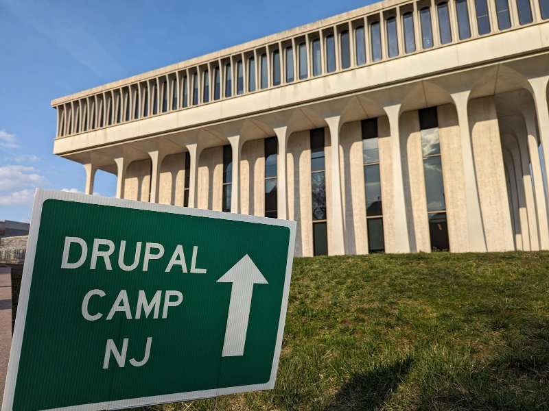 A sign for DrupalCamp New Jersey in front of Robertson Hall