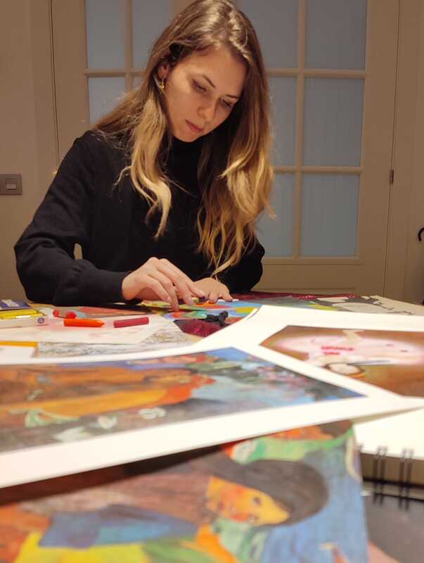 a woman leans over her arts and crafts project.