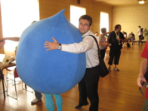 Alex Dergachev hugging big walking Druplicon at Drupalcon Paris