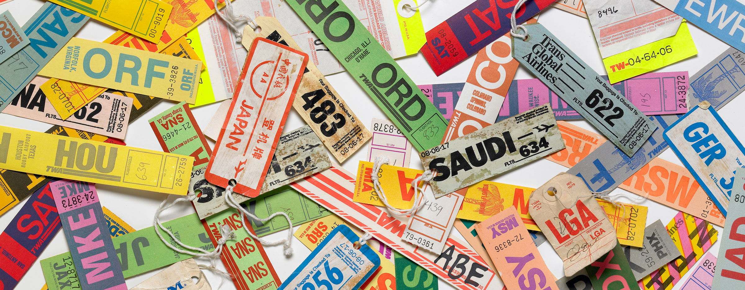 Photo of baggage labels from 1980s airlines such as TWA.