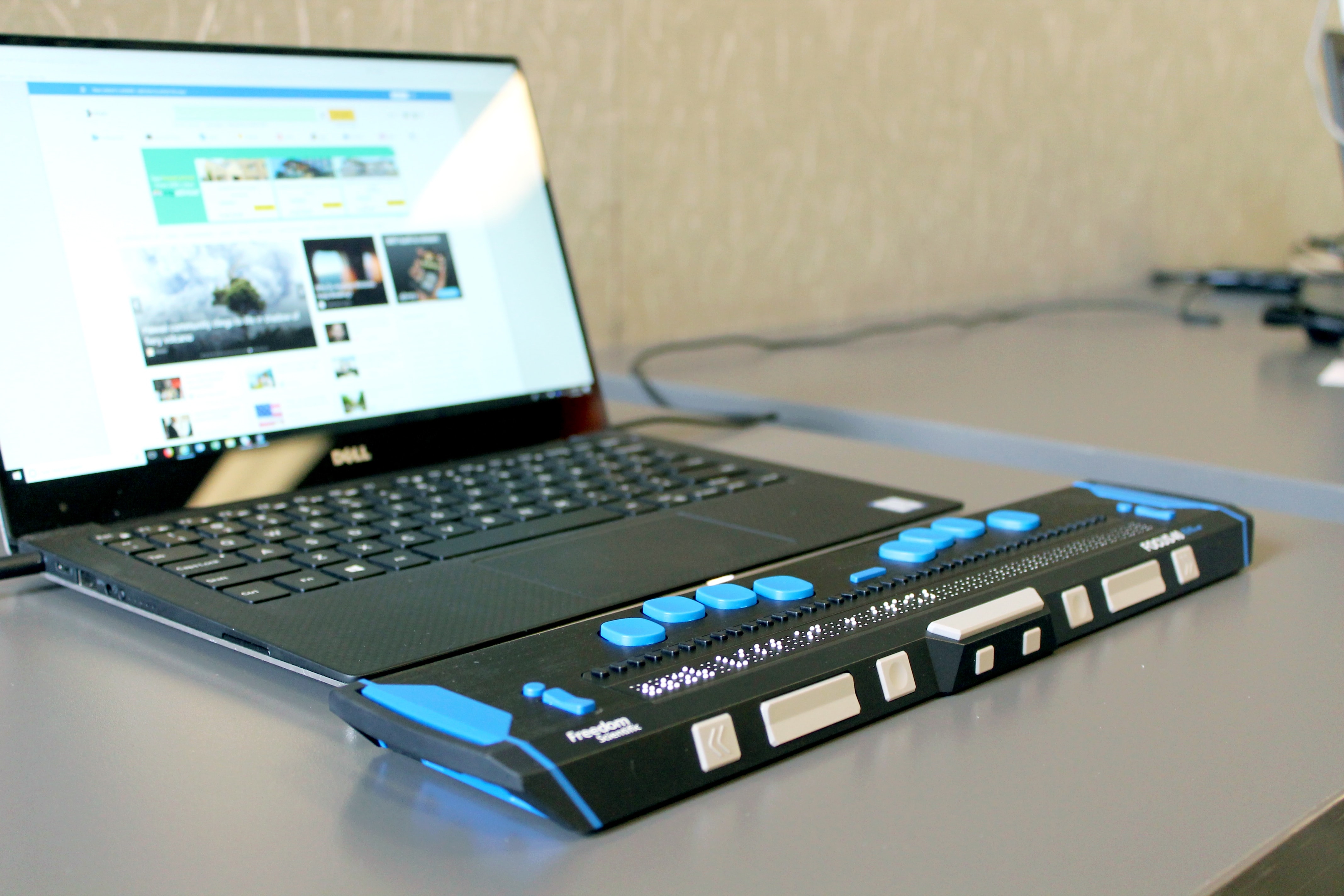 Laptop with braille module attached