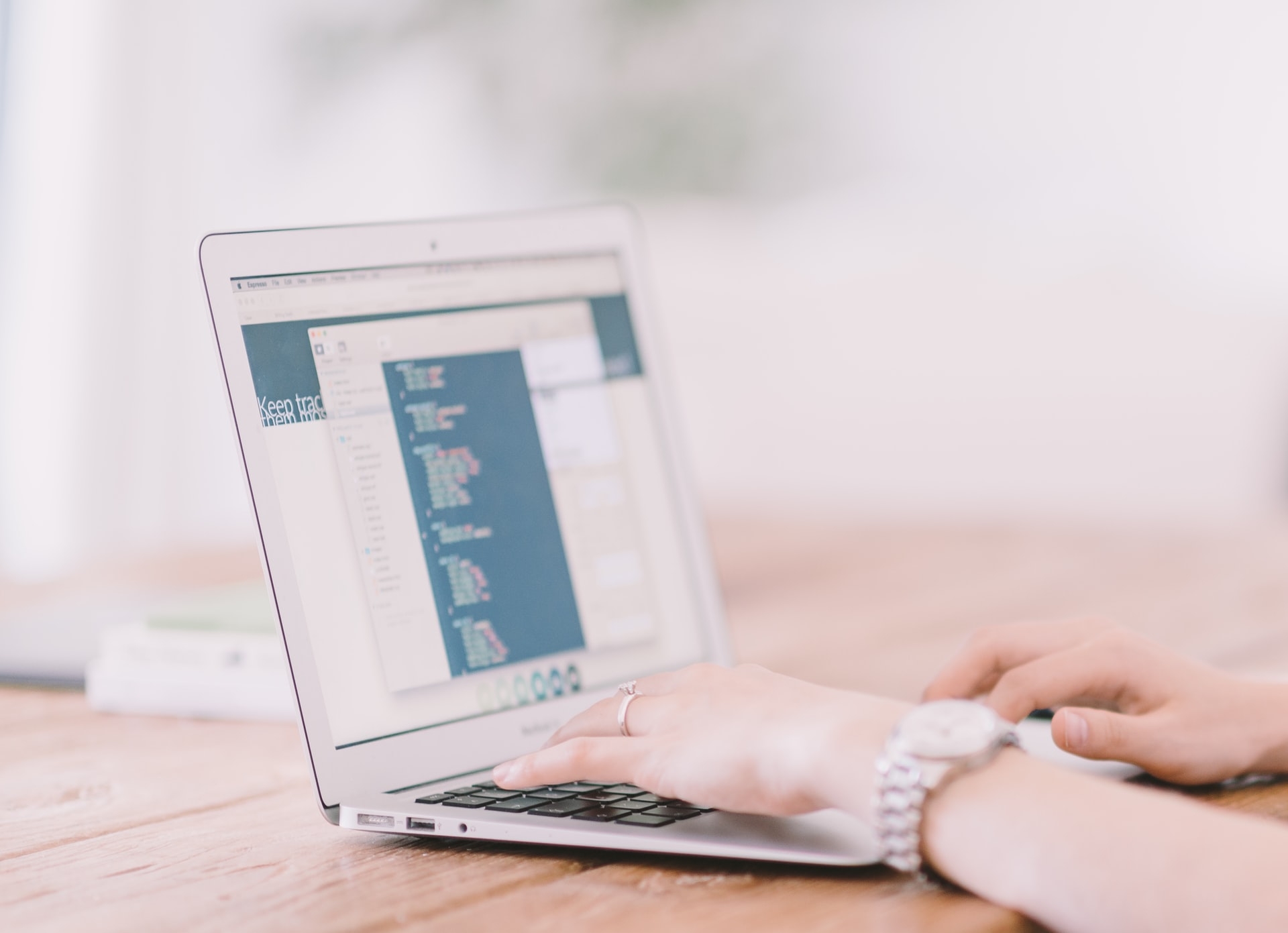 Woman typing on a Mac