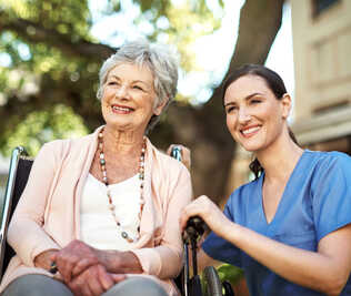 Patient in a wheelcare with a healthcare professional