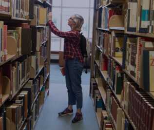 University of Oregon Libraries banner with a person looking at open stacks.