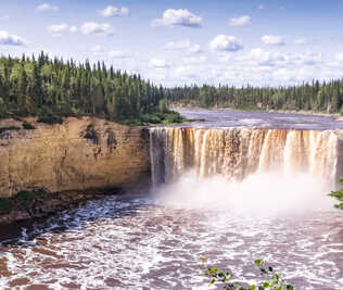 A banner representing the Northwest Territories with a waterfall in a forest.
