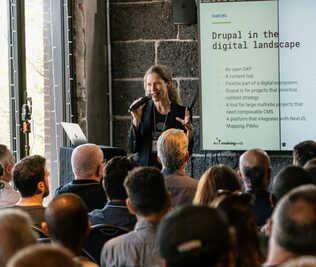 Suzanne presenting in front of a crowd