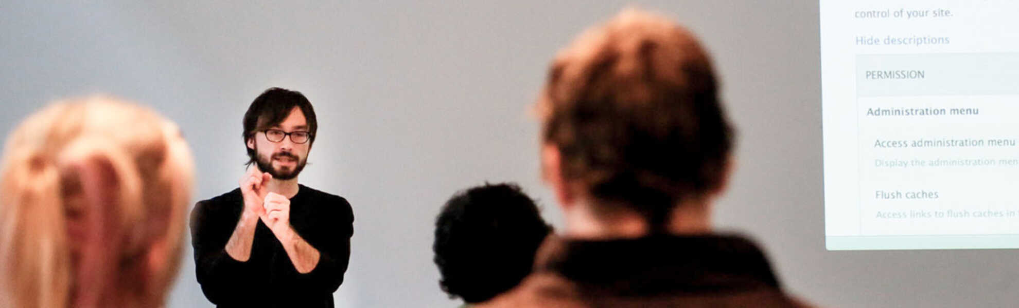 A facilitator giving training to a classroom 