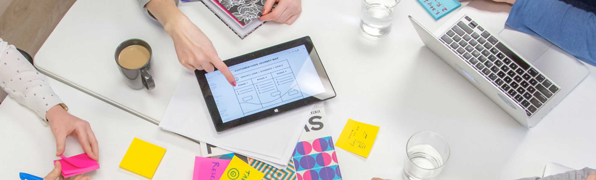 work table with files and a tablet. 