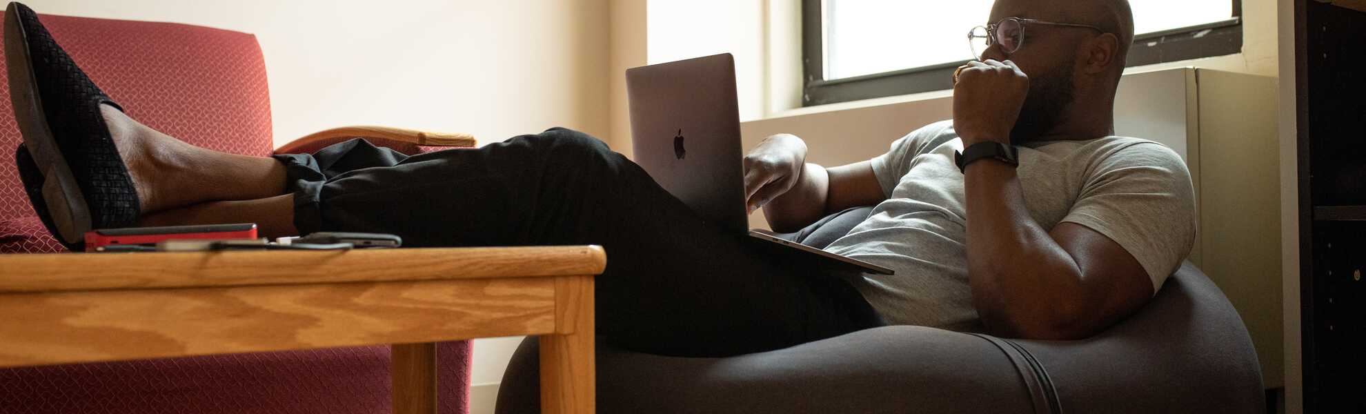 Young man comfortably working from home in a computer