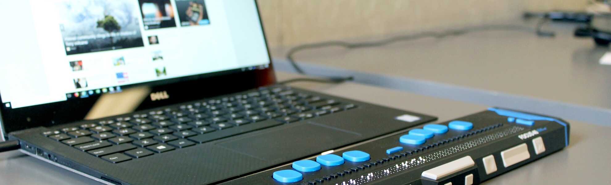 Laptop with braille module attached