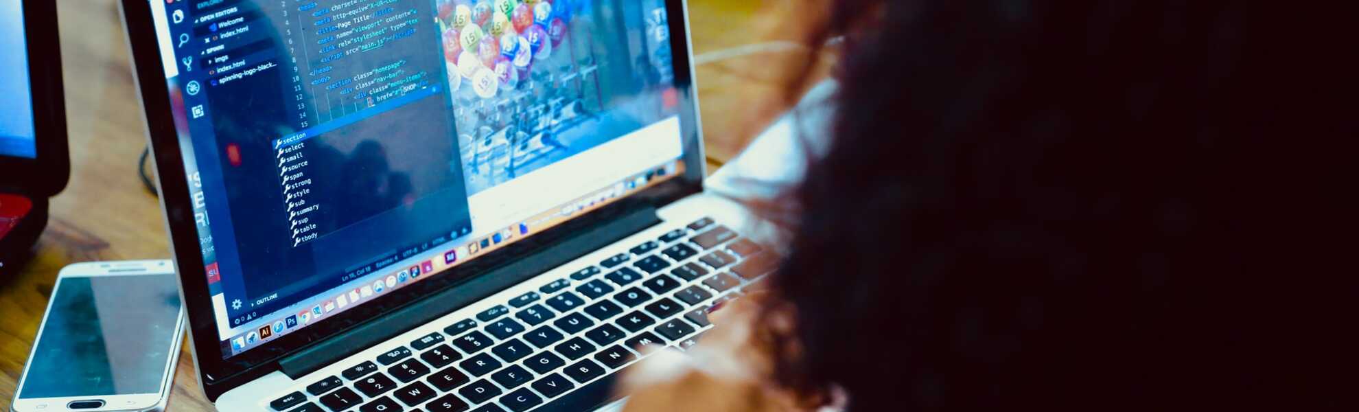Woman coding on a laptop