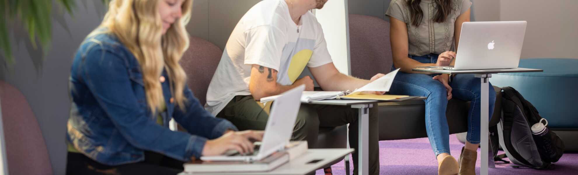 A banner of students studying in a lounge