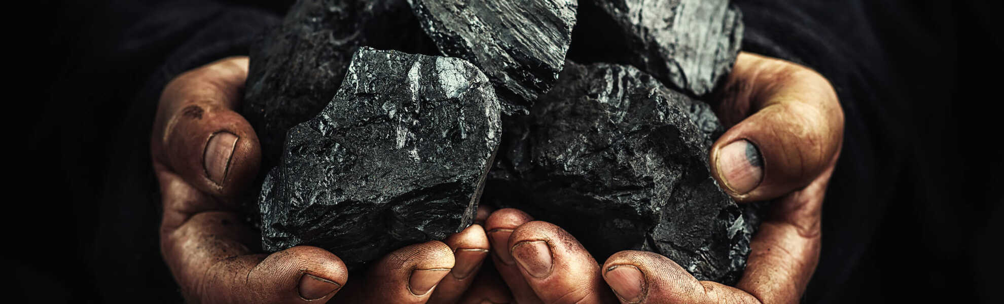 An image with two hands holding a large piece of mineral