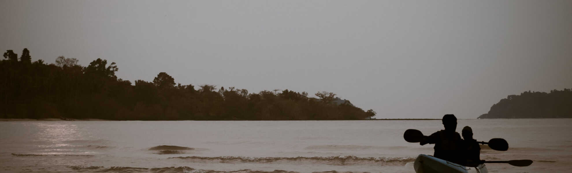 A banner representing NorthwesTel in the NT landscape, featuring a forest and human figures crossing a body of water in a canoe.