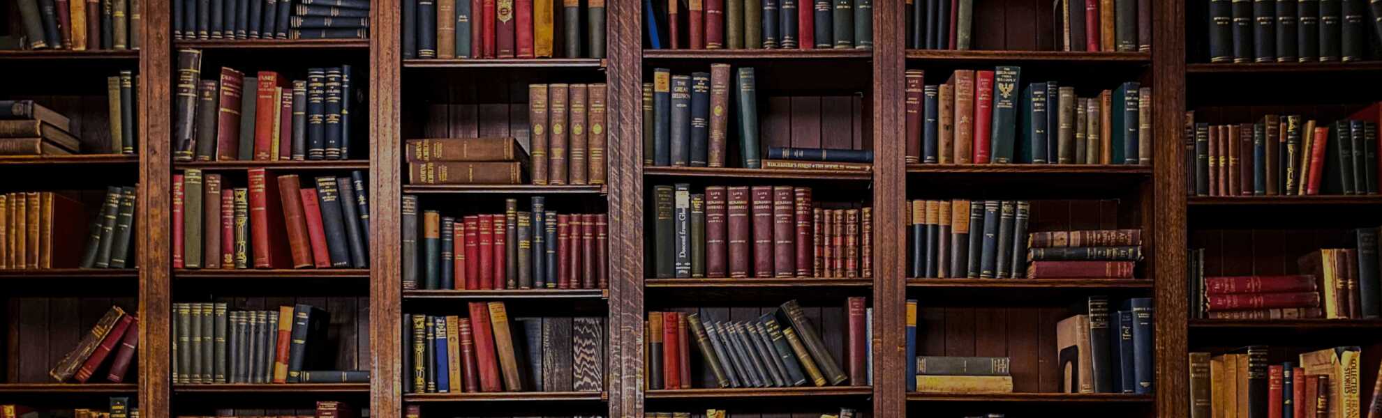A banner showing library stacks full of old books