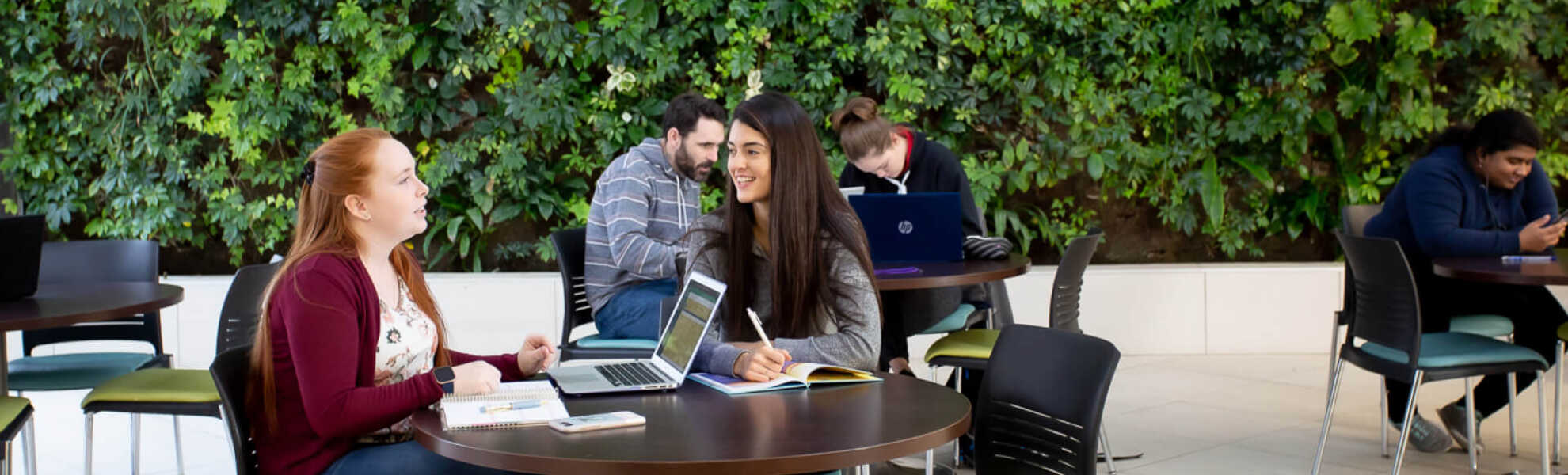 Students sitting at a table outside