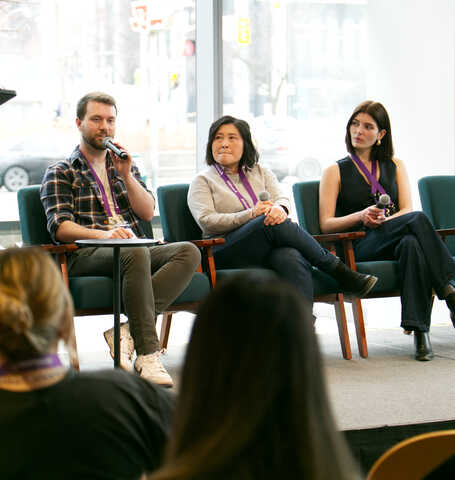 Three panelists speaking on a design systems panel at EvolveDigital Toronto 2026, seated on stage with microphones.