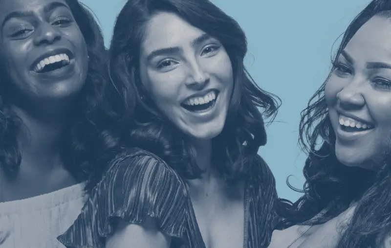 Three young women laughing