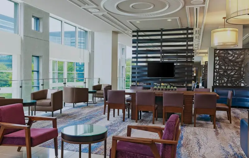 A photo of an empty reception area featuring chairs and tables