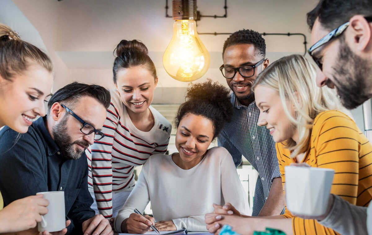 A banner in light tones showing a group of people gathered around a project