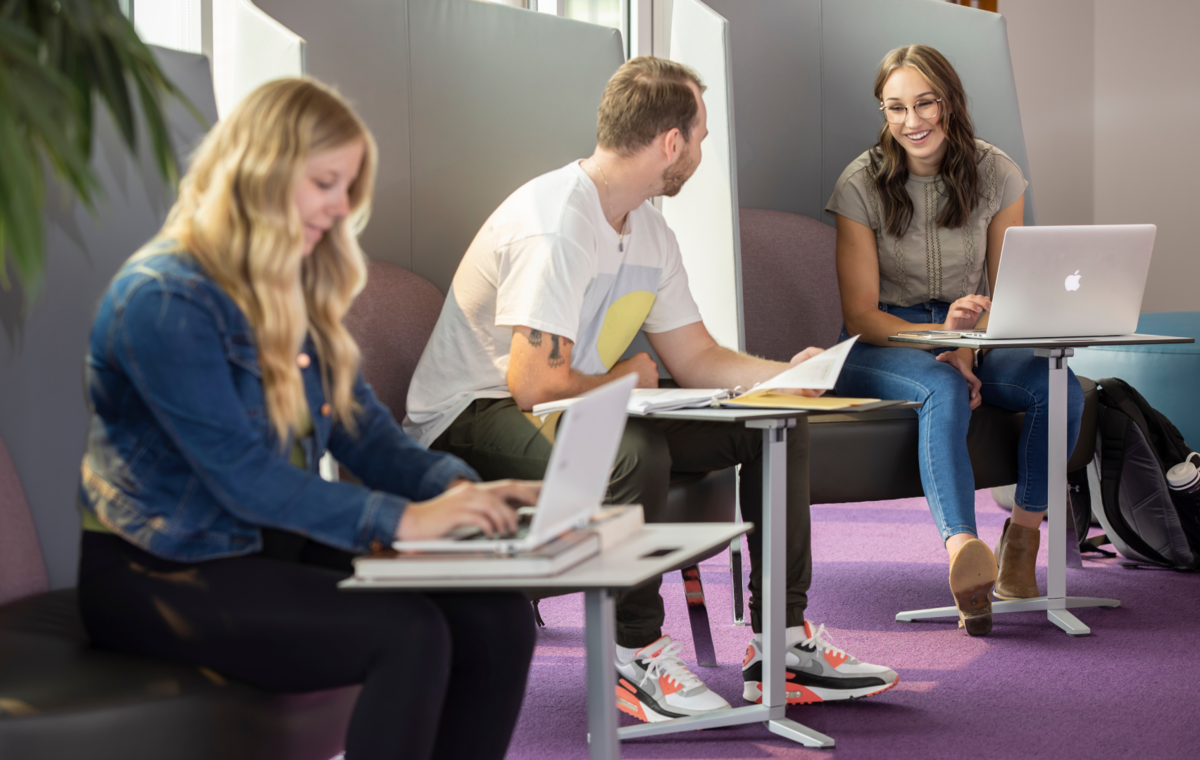 A banner of students studying in a lounge