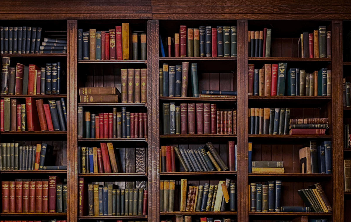 A banner showing library stacks full of old books