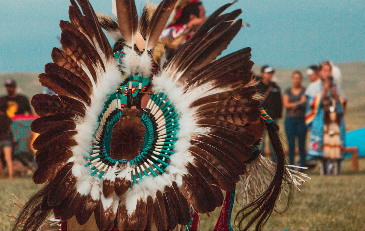 Someone in Indigenous ceremonial dress