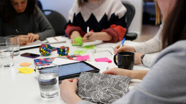 Co-workers collaborating around a table